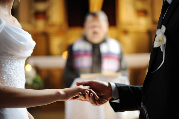 wedding insurance 101 - couple exchanging vows
