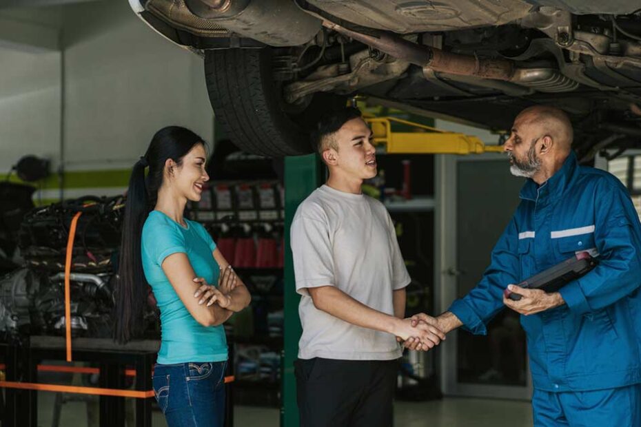 two young adults at auto body shop