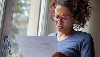 female looking at car insurance policy confused