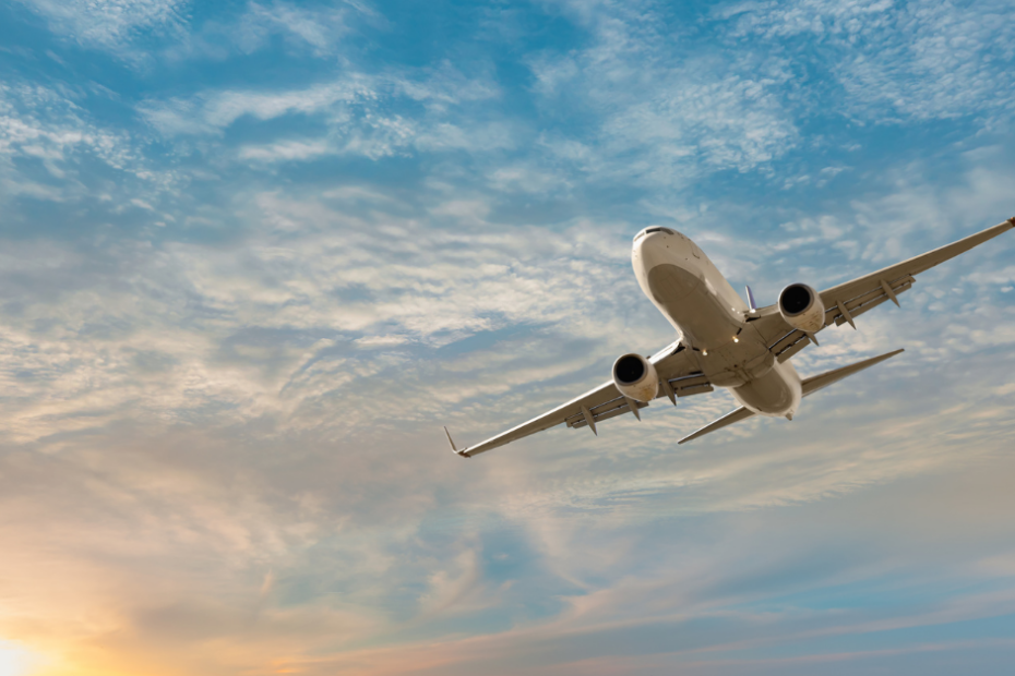 airplane in the sky about to land at sunset