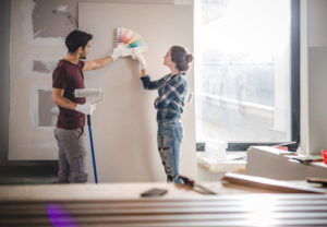 couple painting fixer-upper