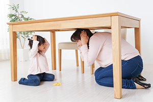 mom and daughter under table