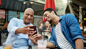 father and son looking at phone