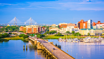 View of Charleston, South Carolina. Buildings and a bridge in the foreground. 