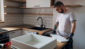 Person working on kitchen cabinets 