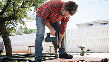 a person working on a home improvement project outside