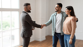 a Realtor with a couple closing a sale