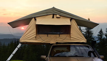 A rooftop tent at sunset fully open