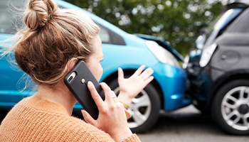 a person on the phone after a car accident