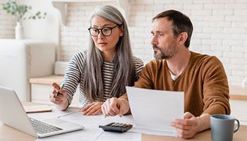 older couple reviewing their insurance before a hurricane