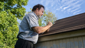 A person professional doing a roof inspection 