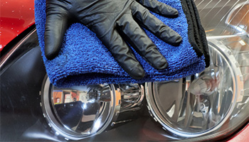 a person polishing their headlights