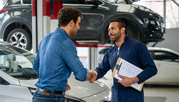 a person shaking hands with a mechanic