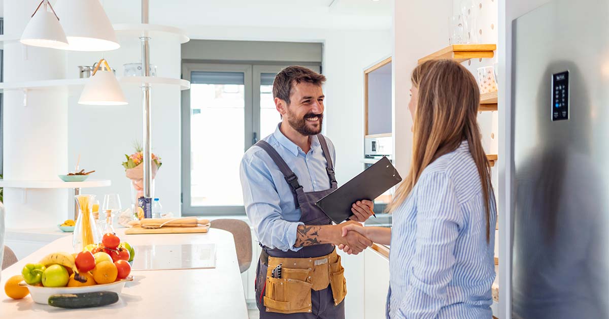 a person shaking hands with a home repair employee
