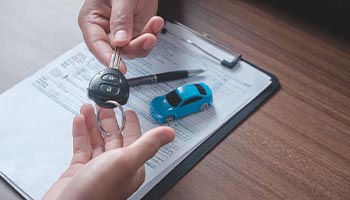 a person getting the keys to their rental car