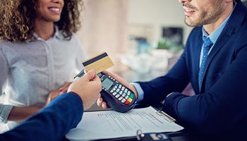 A person using their credit card to be covered for rental car insurance