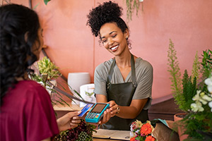 customer paying with credit card at flower shop