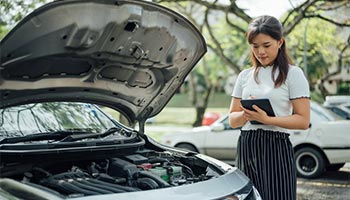 a car insurance agent assessing a car for damage