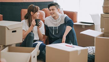 a young couple with renters insurance moving into their rental home