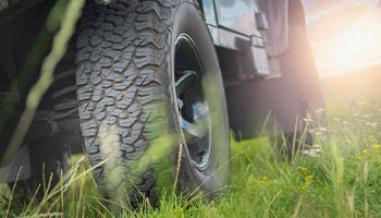 new car tires on a grassy field 