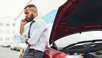 A person on the phone with their car insurance provider after getting into an accident