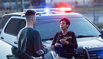 a person speaking with a police officer and filing a police report