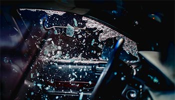 a car theft where a theif breaks a car window