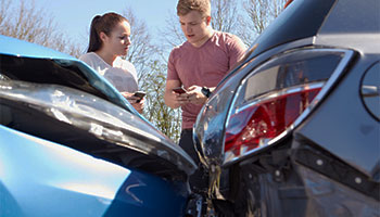 two drivers involved in a car accident exchanging their information