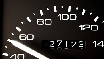 a zoomed in view of a car's odometer with 27,000 miles