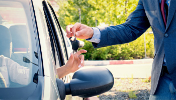 a person getting the keys to their new car