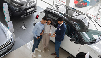 A couple purchasing a new car from the dealership