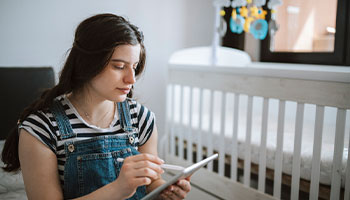 a person creating a home inventory list starting in the nursing room