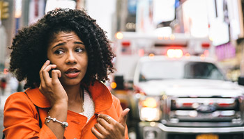 Women on the phone with 911 after a car accident