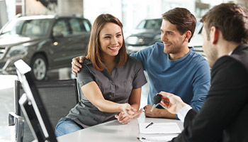 a person purchasing a new car at the dealership