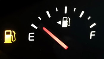 Low fuel indicator on a car's dashboard