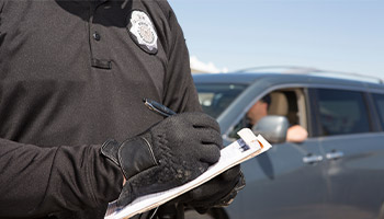 an officer writing a speeding ticket