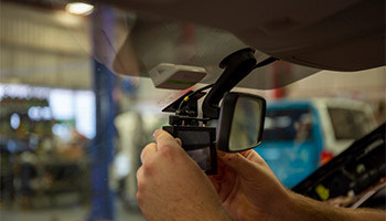 a person installing a dash cam