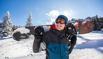 a person wearing eye goggles while snow boarding