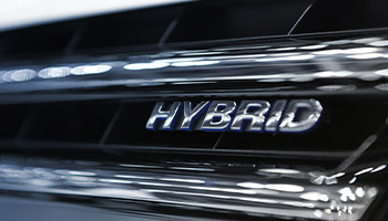 view of a hyrbid car's front end that says hybrid