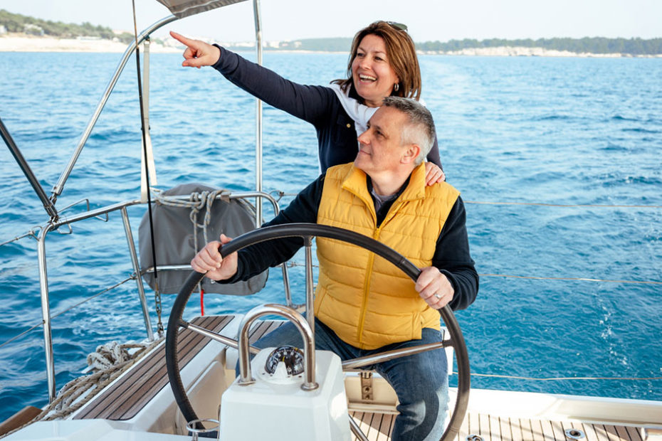 mature couple on boat practicing boat safety