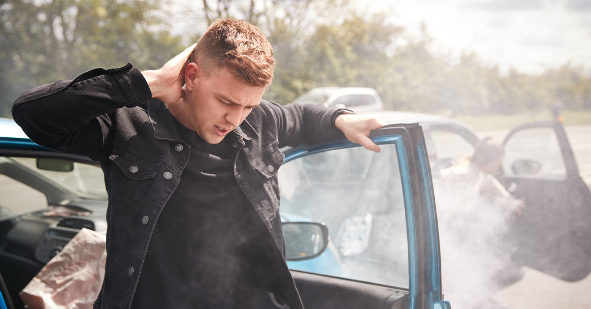 man exiting car with neck injury