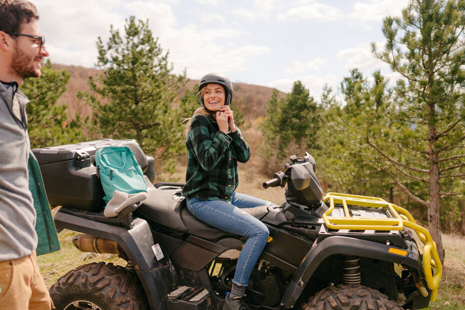 couple preparing to ride on their ATV