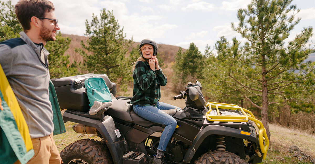 couple preparing to ride on their ATV