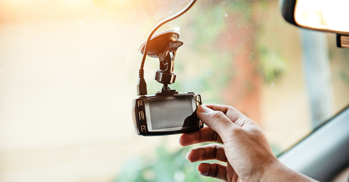 person installing a dash cam