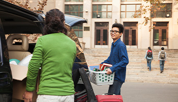 college student arriving at college with parent's car