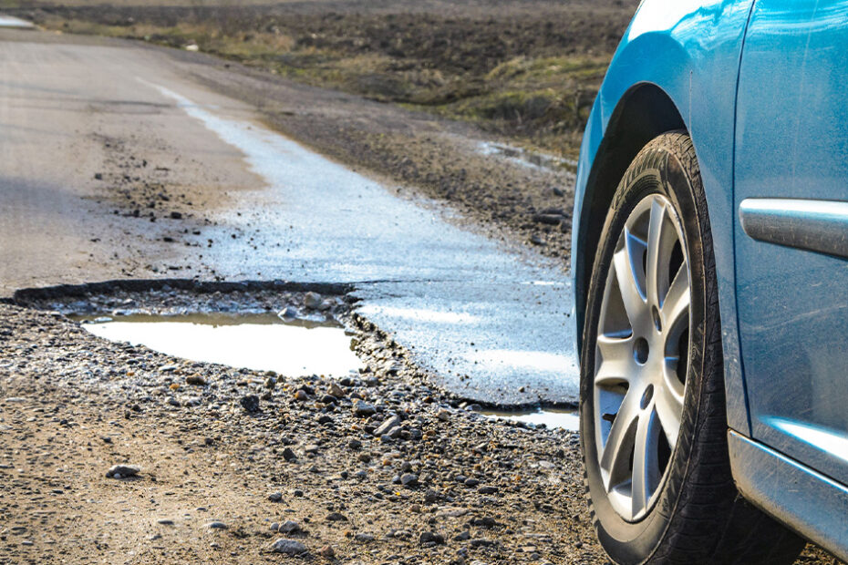 car about to drive over a pot hole that will affect vehicle performance