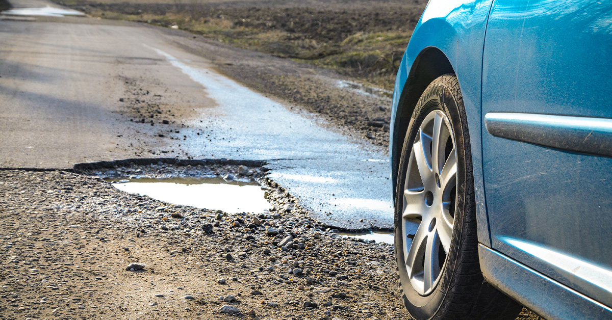 car about to drive over a pot hole that will affect vehicle performance