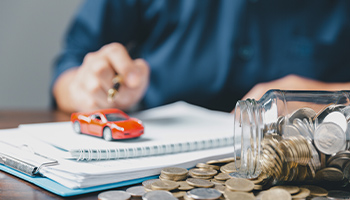 money and toy car on table 