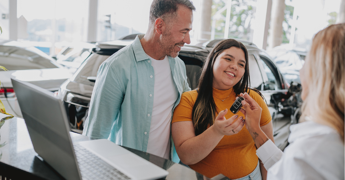 father and daughter buying a new car