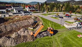 dump truck dropping off dirt for landscaping business